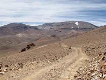 A Jotabeche vulkán látványa a terepen nyugati irányból. Felismerhető a magányos gleccser a vulkán nyugati oldalában és a szomszédos Darwin vulkán (balra)